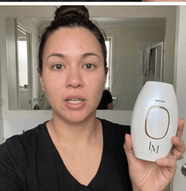 Customer holding Lumimor IPL in mirror
