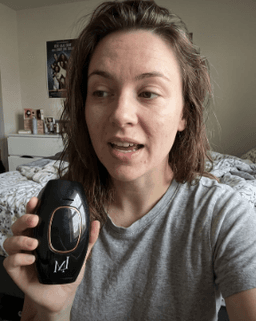 Customer holding black Lumimor IPL device