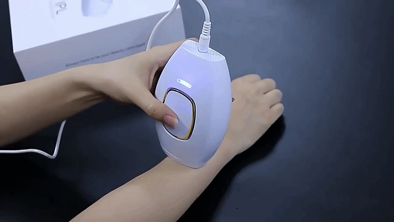 Lumimor IPL device flashing on a forearm during an at-home treatment
